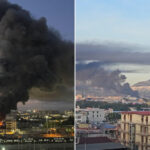 Immense incendie à Naples : entrepôt en feu et dense colonne de fumée noire visible à travers le Golfe